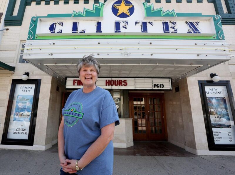 Theatre owner in front of her theatre